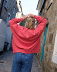 Back_seam_of_washed_red_oversized_sweatshirt