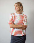 Person wearing a red and white striped shirt against a plain background