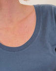 lady wearing navy blue scoop neck t shirt